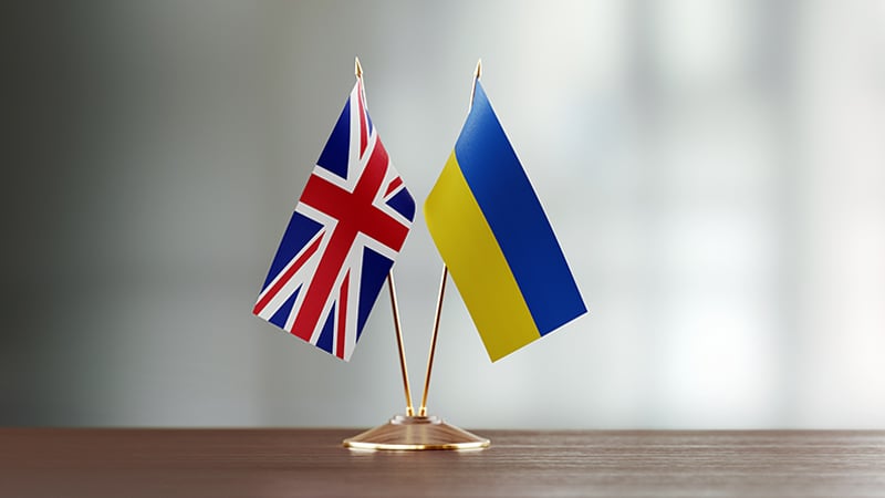 UK and Ukraine miniature flags together on a table