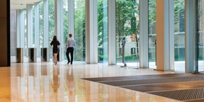 Two colleagues walking through reception