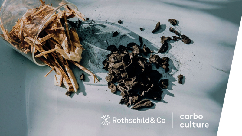 Wood in jar and biochar on table with Rothschild & Co and Carbo Culture logo