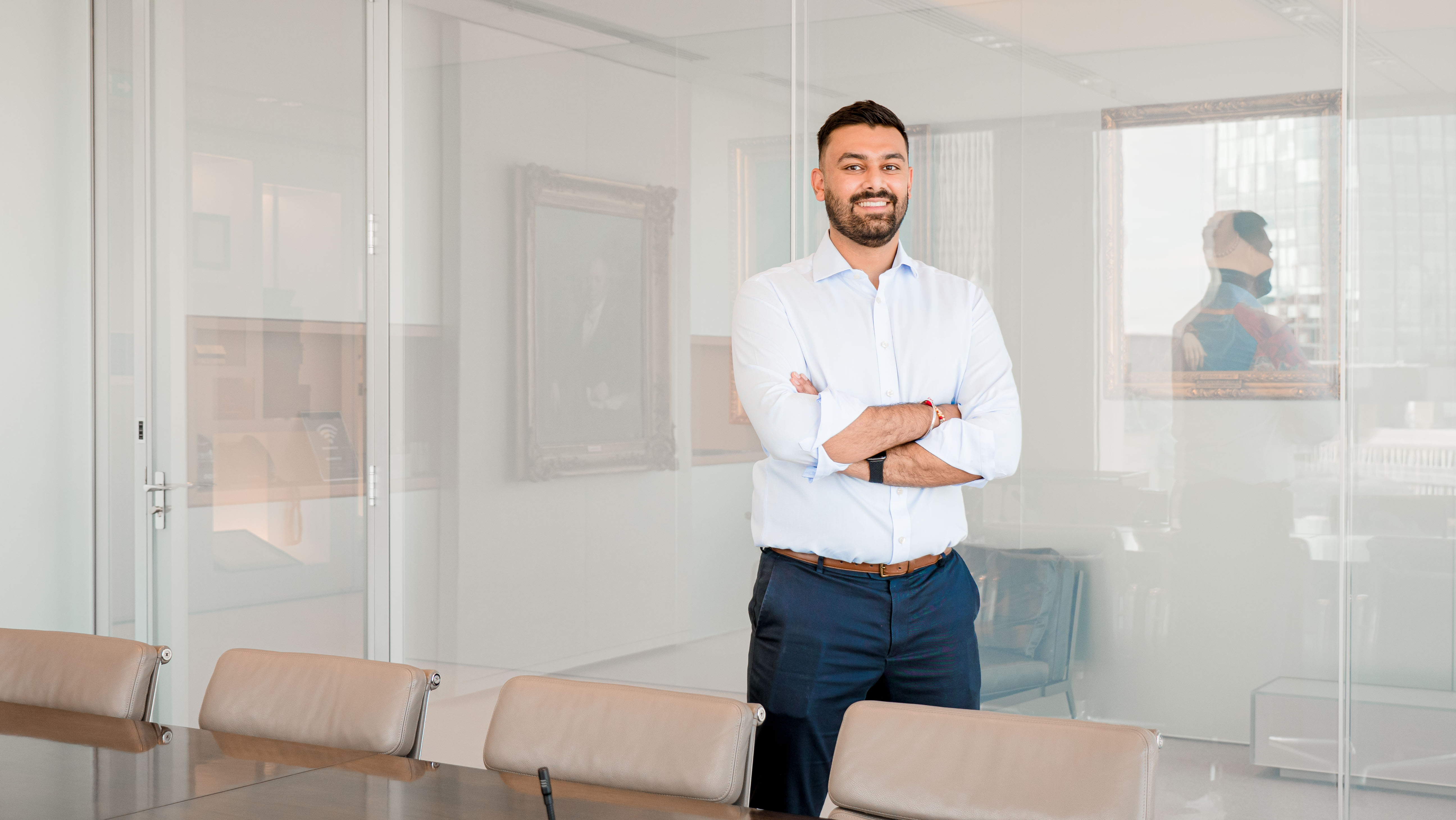 Rothschild and Co team member Inderpal standing in meeting room 