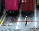 man walking near containers