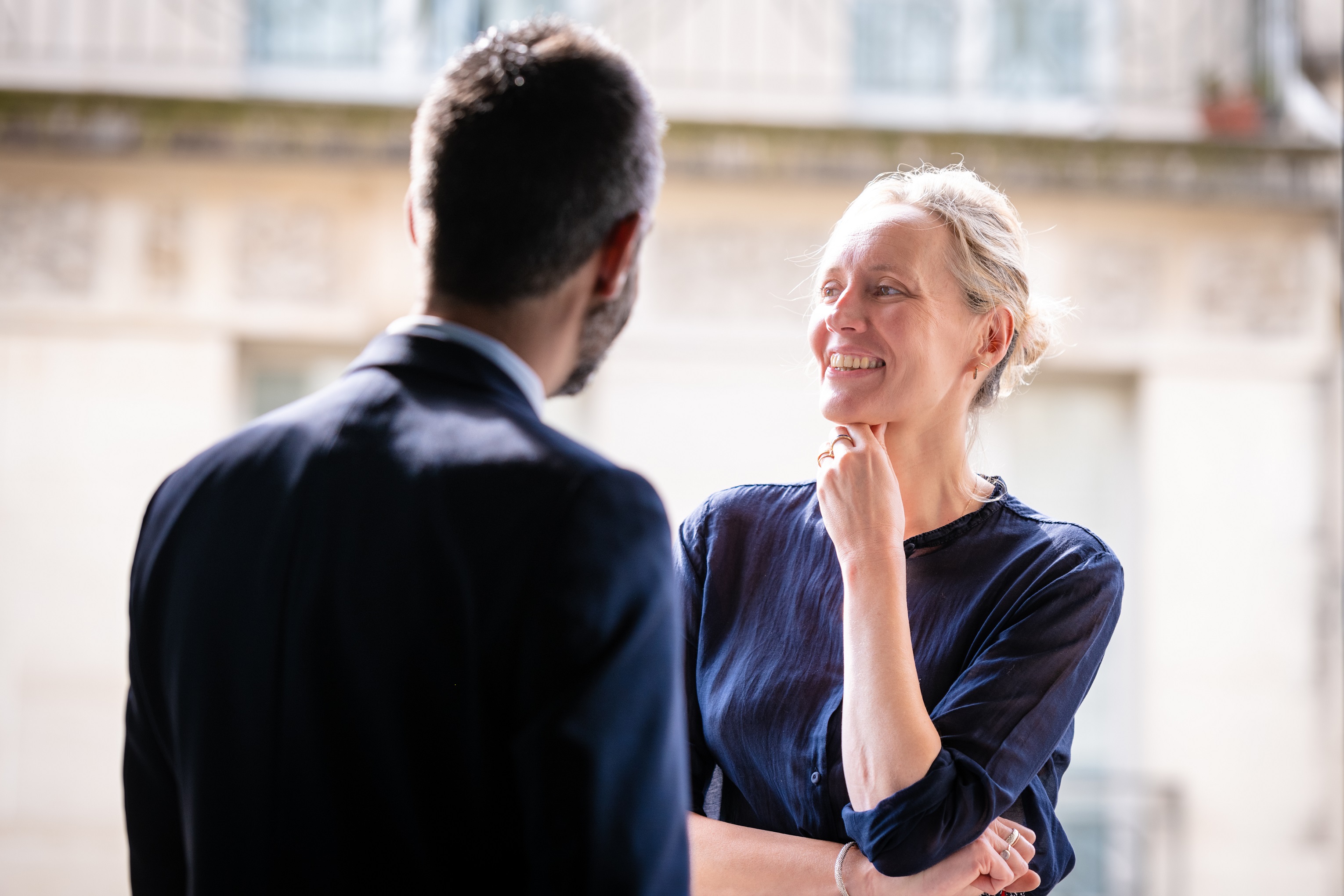 Two Asset Management Europe colleagues talking at Rothschild & Co's Paris office